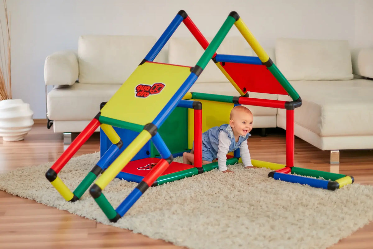 Baby crawling through a colourful QUADRO playhouse with roof and ramp