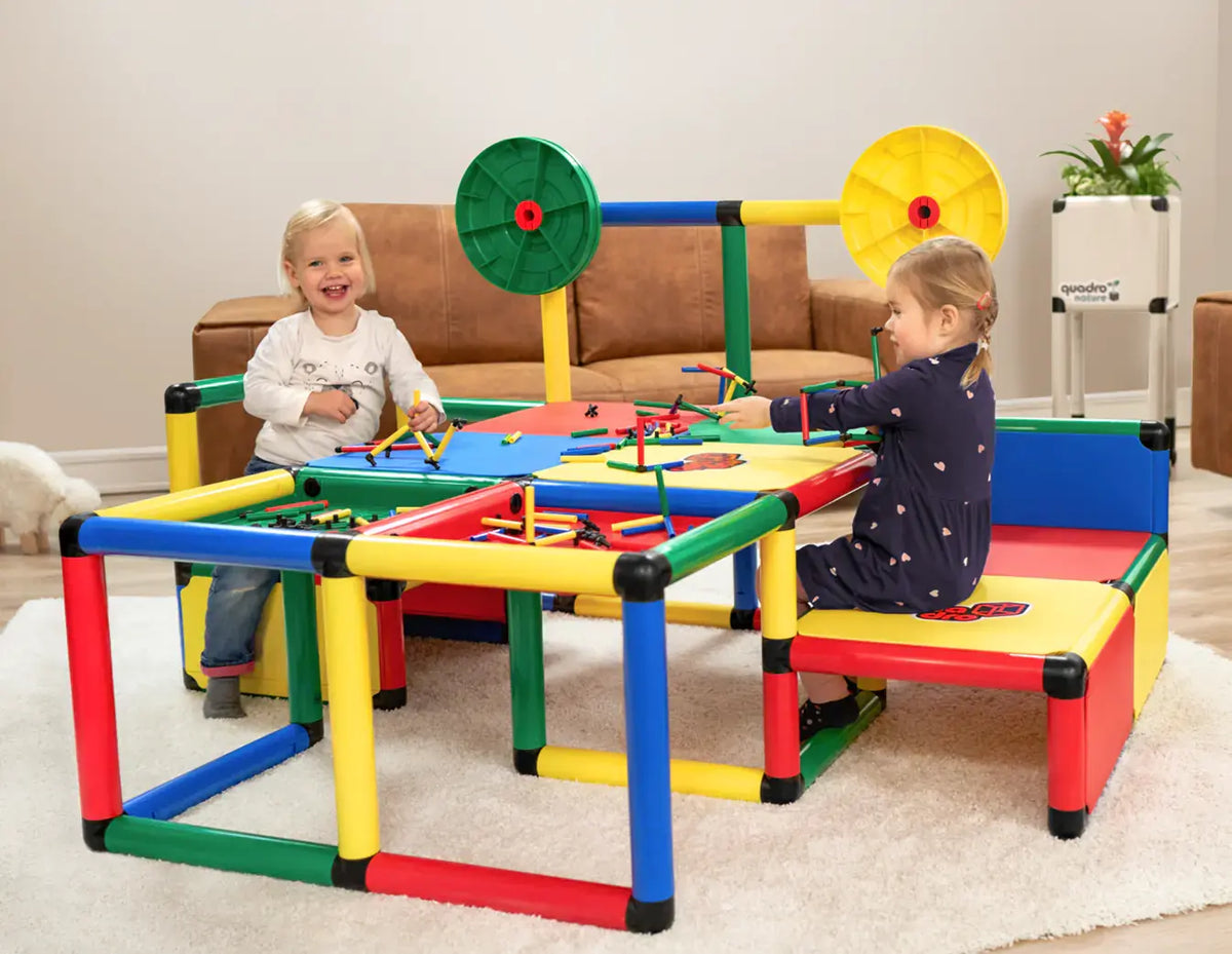 Two children creating artwork at a large QUADRO Evolution activity table