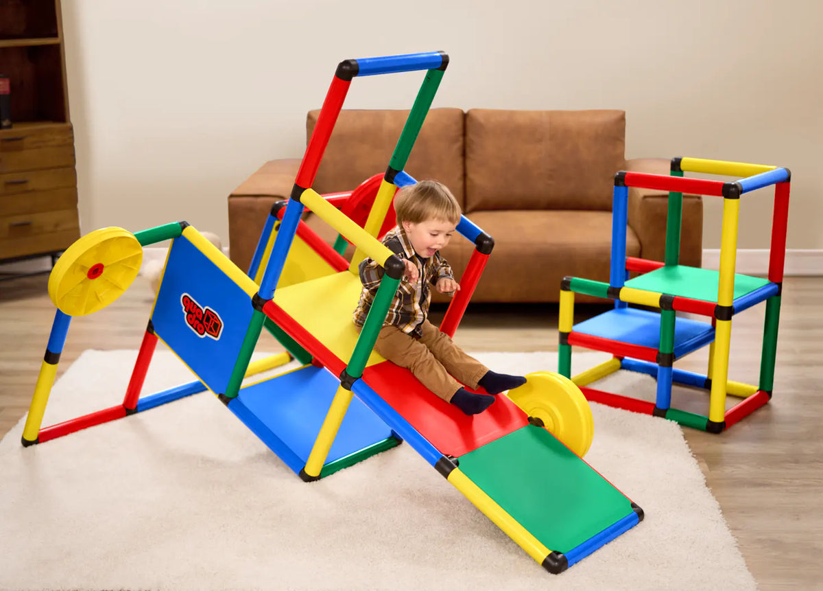Child riding a colourful QUADRO Evolution seesaw indoors