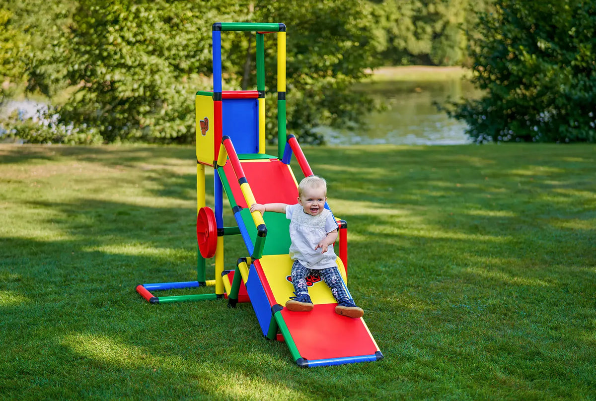 Toddler walking beside a QUADRO Evolution tower with long ramp outdoors