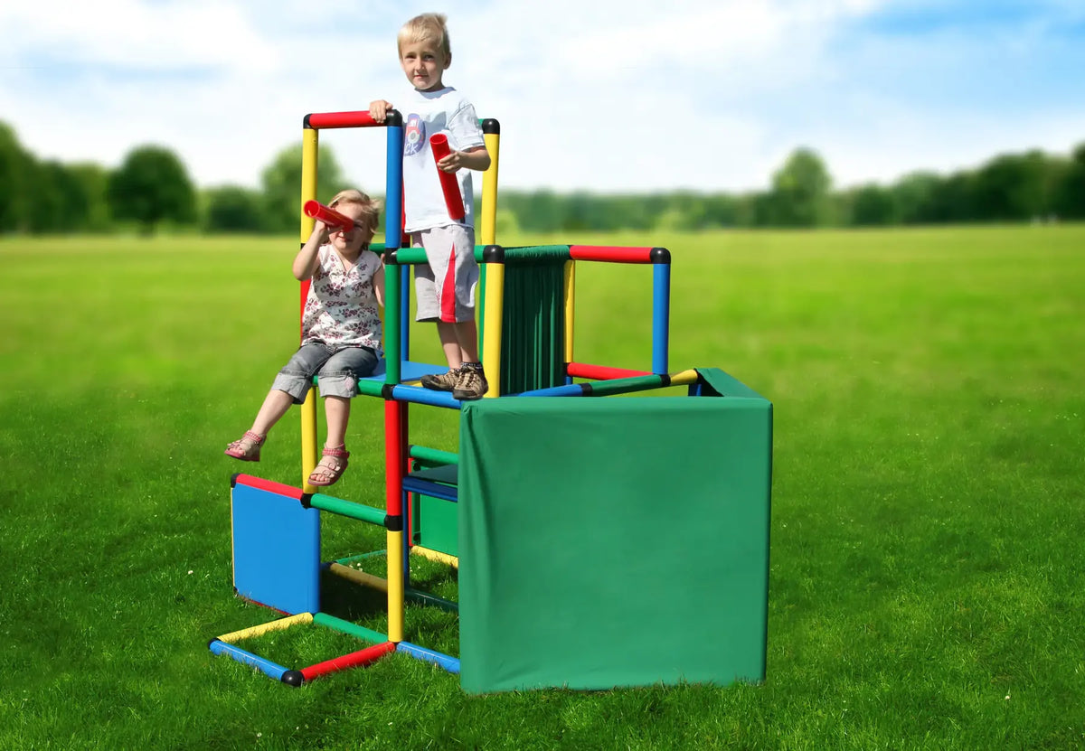 Three children playing on a tall QUADRO Universal tower with fabric panels