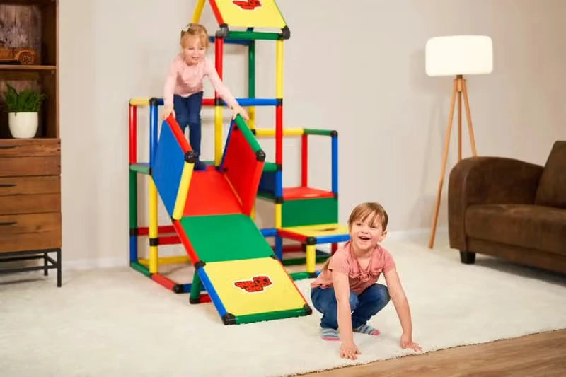 Children climbing and sliding on an indoor QUADRO tower with roof and ramp