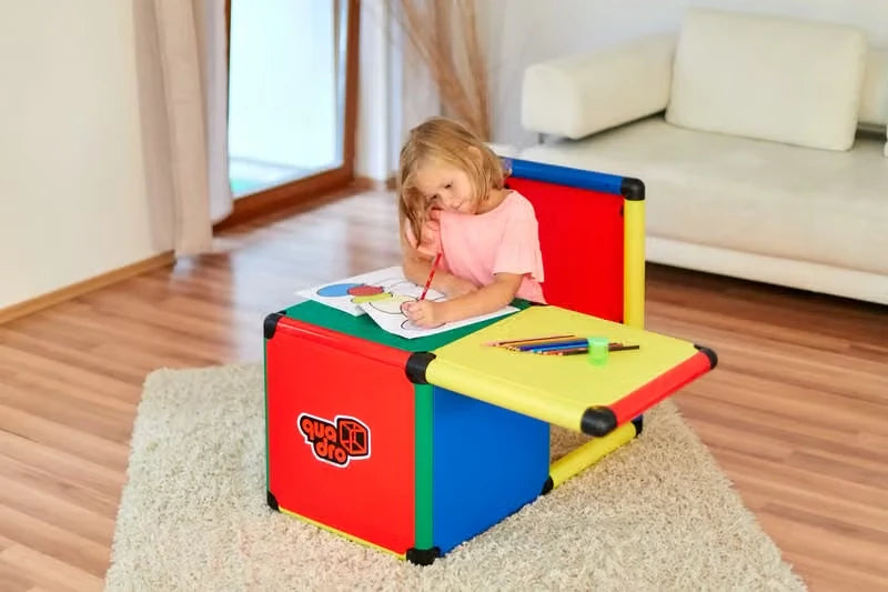 Child drawing at a compact QUADRO desk made with coloured half panels