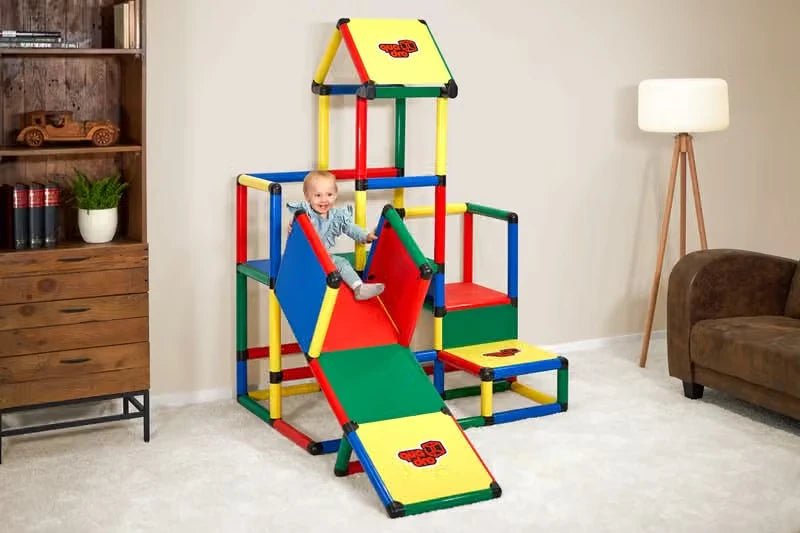 Toddler seated on the ramp of an indoor QUADRO upgrade tower with roof